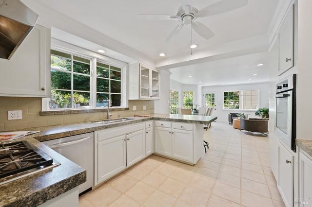 a kitchen with stainless steel appliances granite countertop a sink and a stove