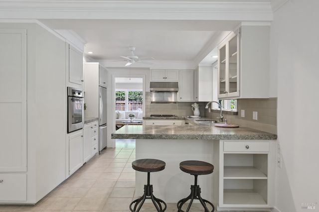 a kitchen with stainless steel appliances granite countertop a sink and cabinets