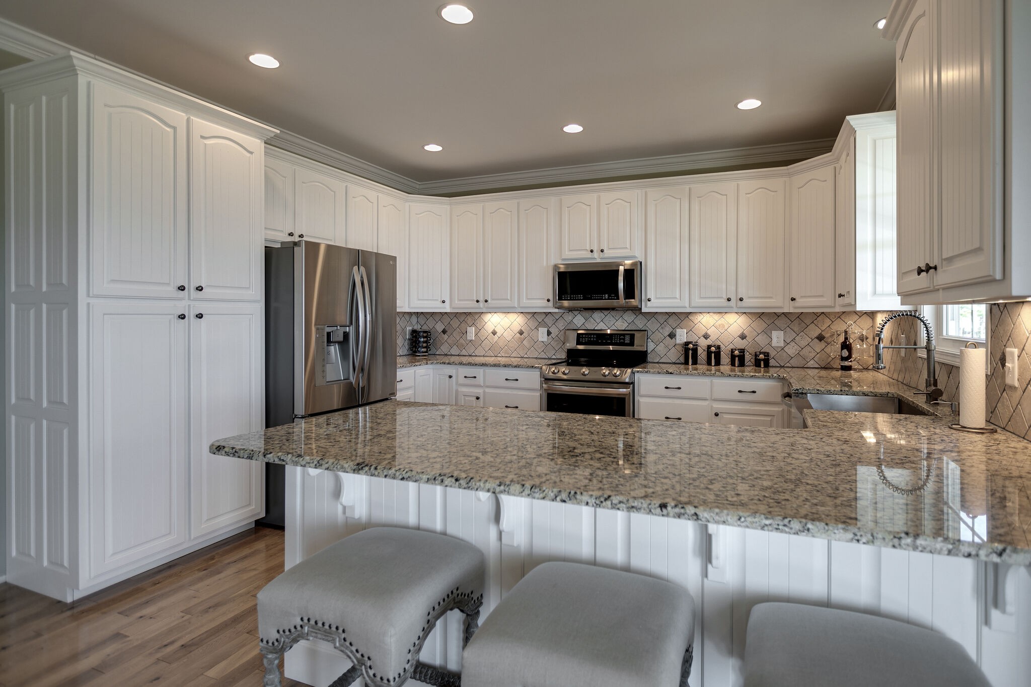 58 Locker Road Summertown, TN 38483 - Photo 7 of 28 a kitchen with stainless steel appliances granite countertop a stove a sink a refrigerator a dining table and chairs