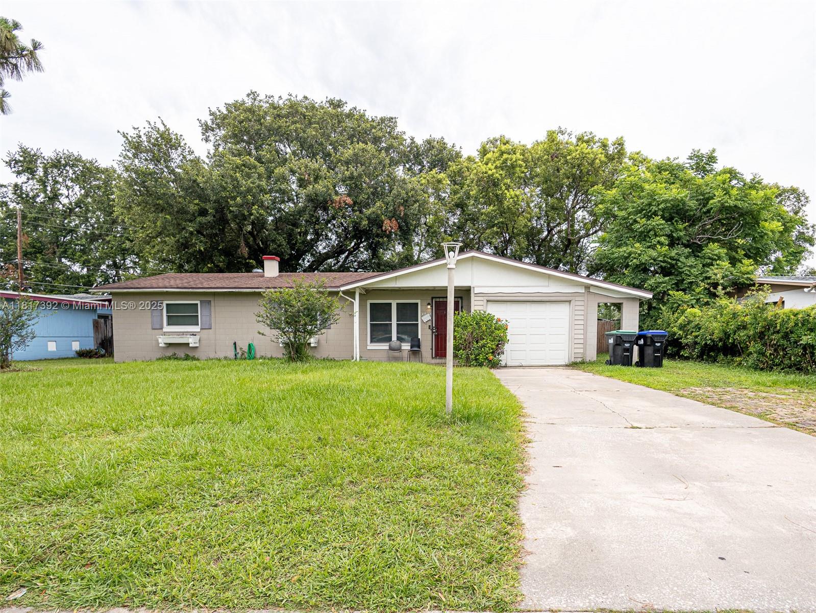 a front view of house with yard and trees