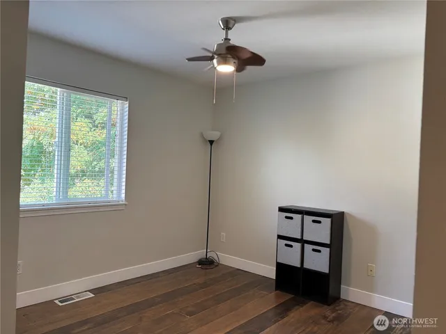 a view of a room with a hardwood and a window