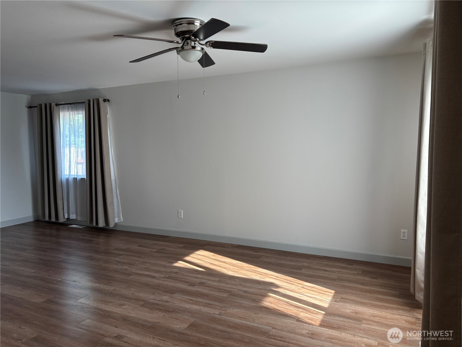 6401 Brycen Lane Southwest, Unit B Olympia, WA 98512 - Photo 4 of 20 a view of empty room with wooden floor and fan