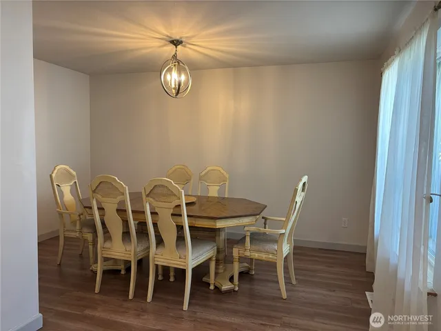 a dining room with furniture and wooden floor