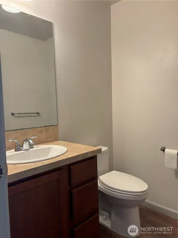a bathroom with a toilet a sink and mirror