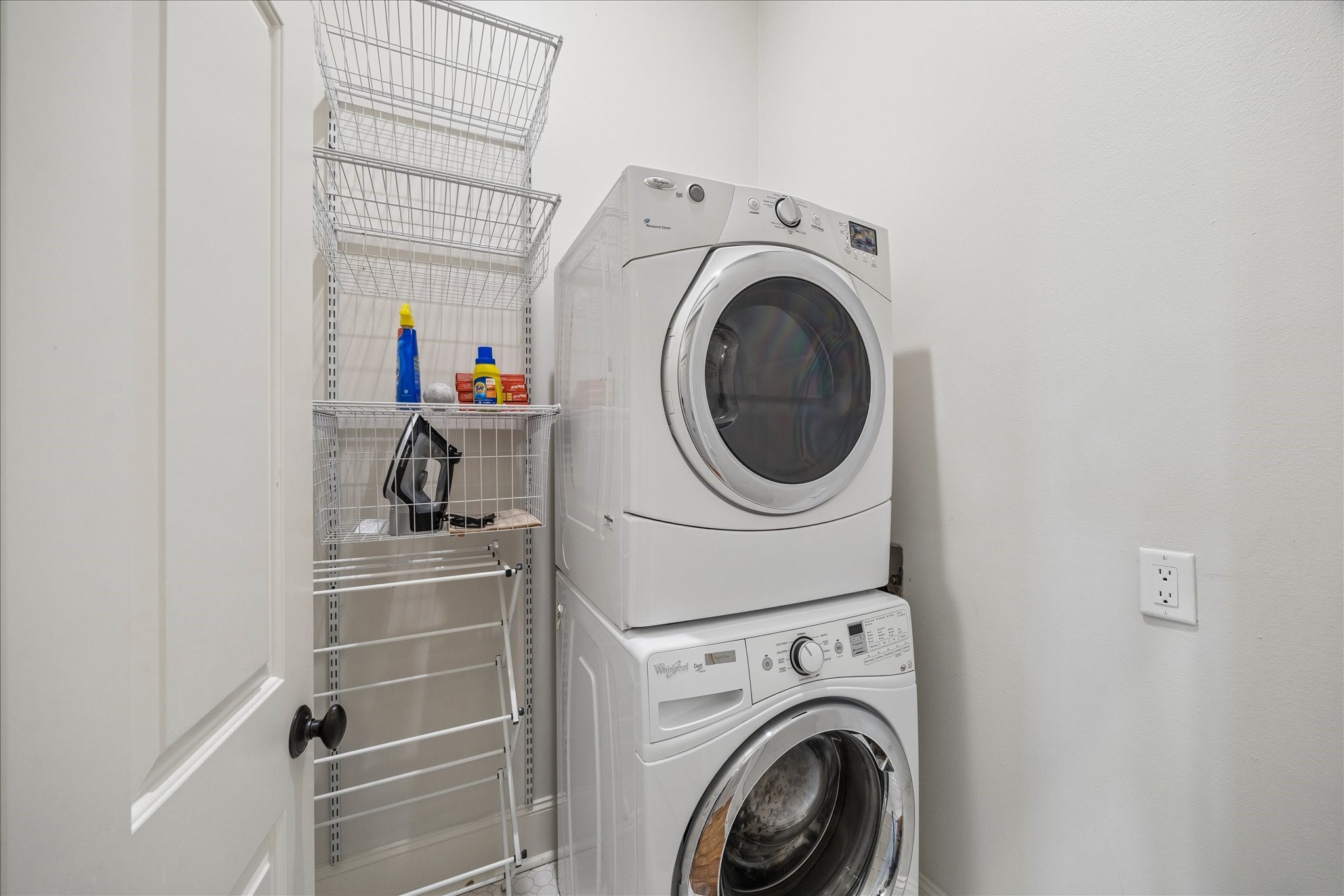710 Positano Road Galveston, TX 77550 - Photo 25 of 36 The laundry features a stackable washer and dryer with additional storage.