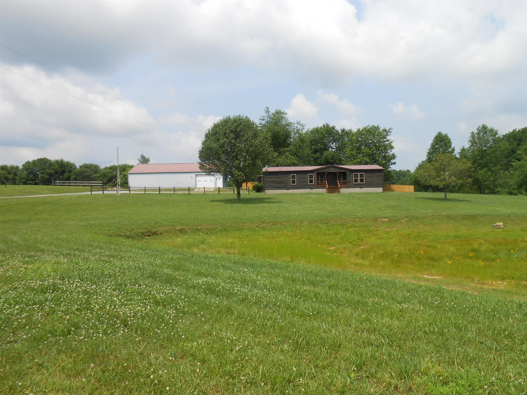 283 Freeland Road Portland, TN 37148 - Photo 1 of 21 a view of a green yard with a lake
