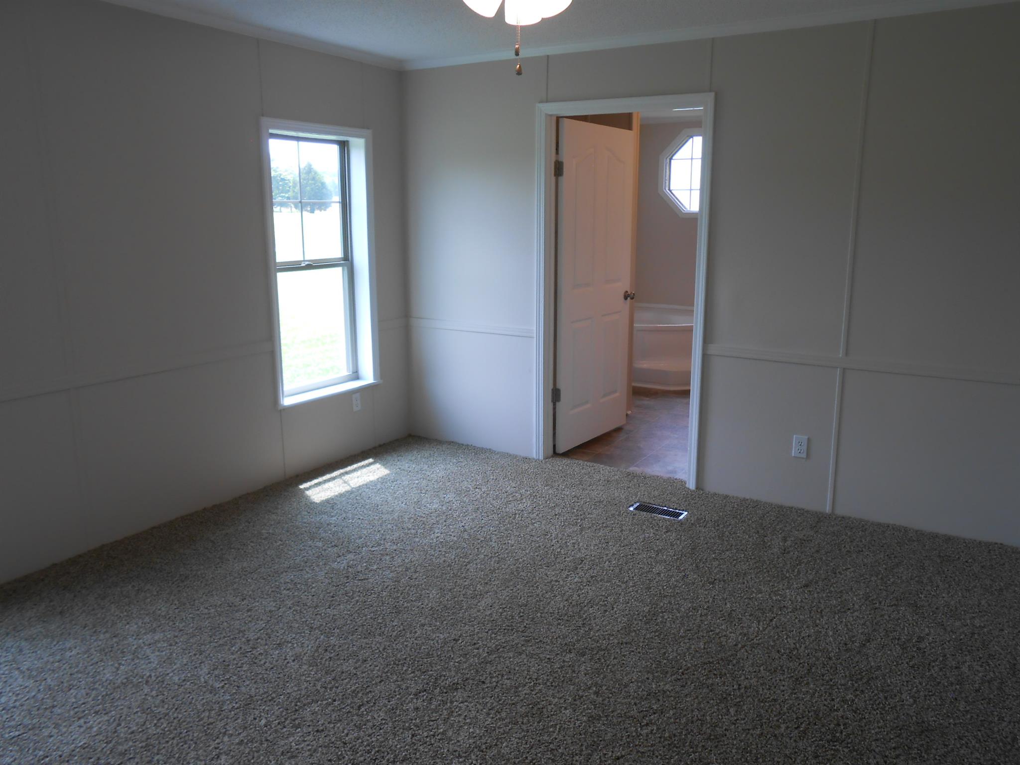 283 Freeland Road Portland, TN 37148 - Photo 12 of 21 an empty room with windows and entrance to other room