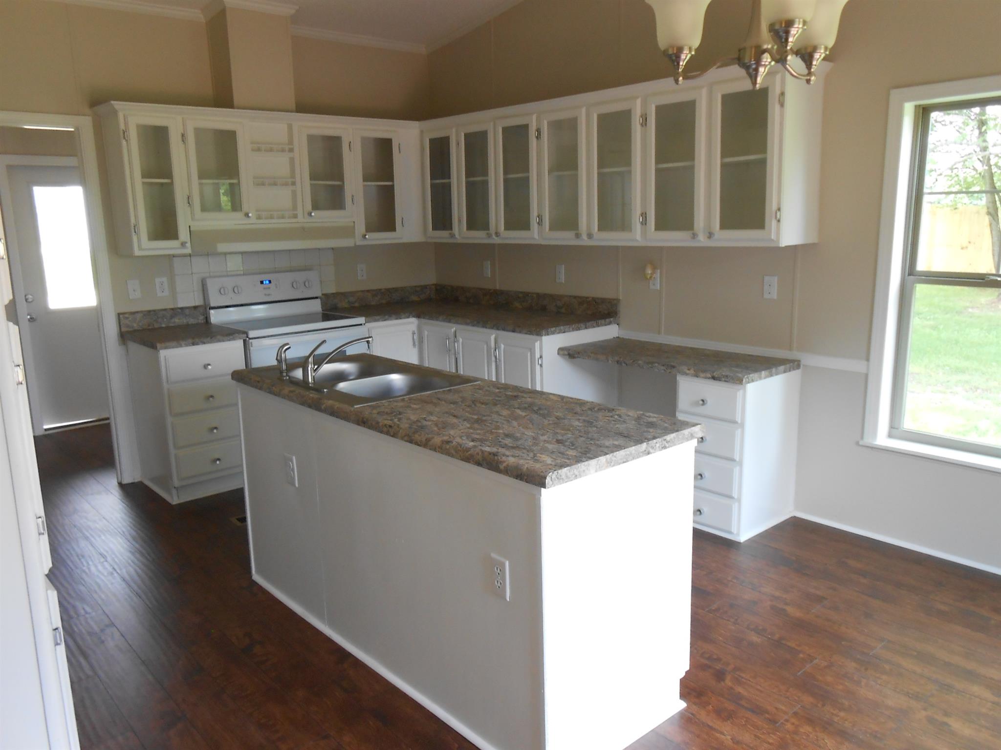 283 Freeland Road Portland, TN 37148 - Photo 8 of 21 a kitchen with a stove a sink and a refrigerator