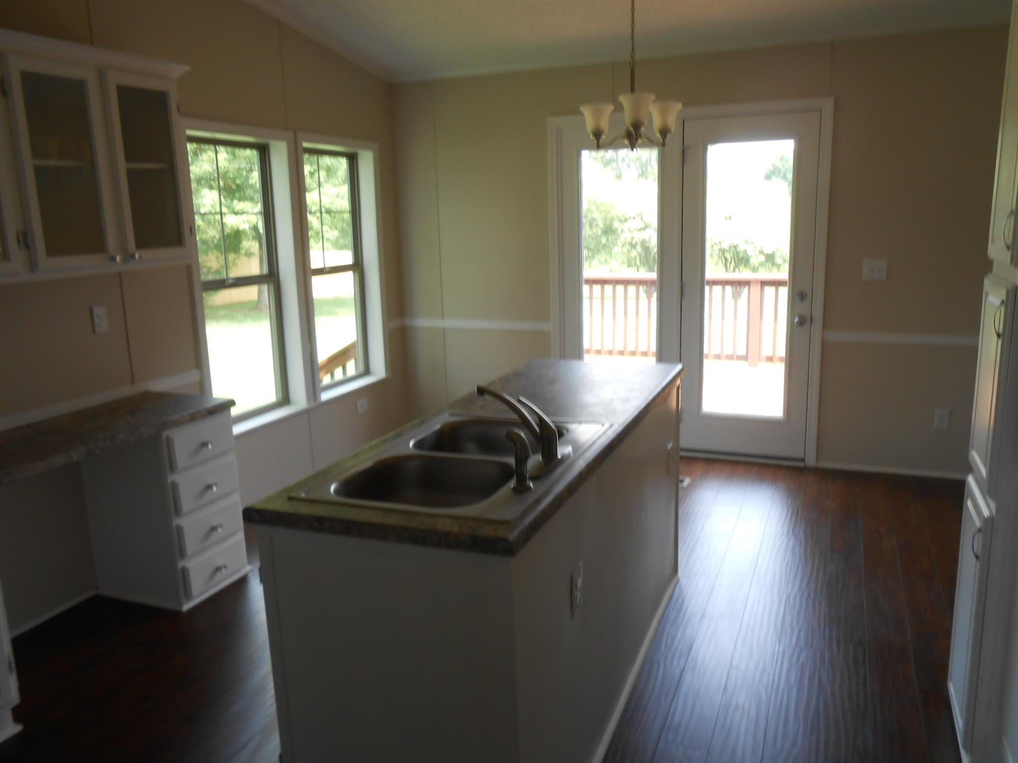 283 Freeland Road Portland, TN 37148 - Photo 9 of 21 a kitchen with granite countertop a sink stove and cabinets