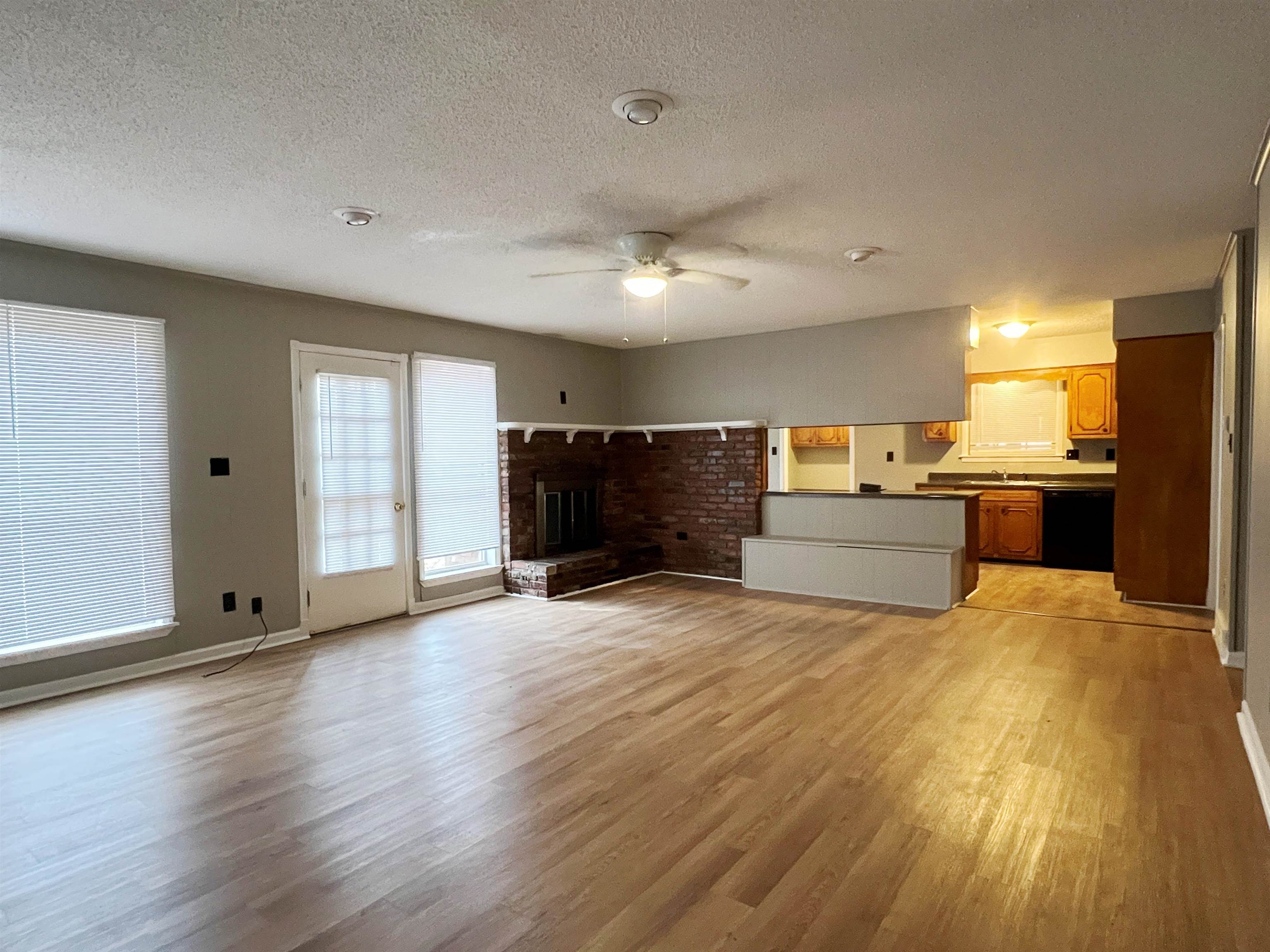 3169 Flint Drive Memphis, TN 38115 - Photo 2 of 13 a view of an empty room and kitchen with wooden floor