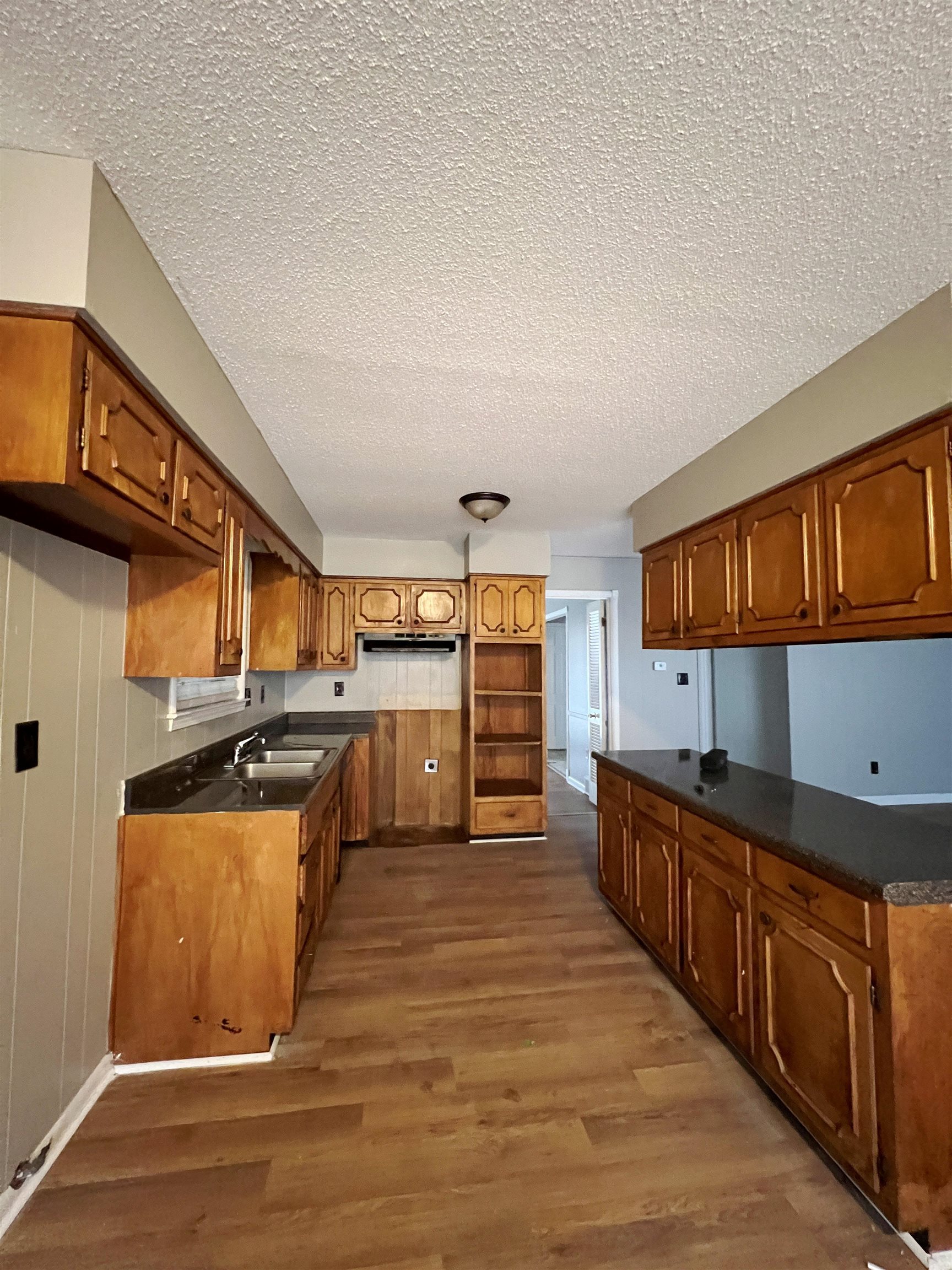 3169 Flint Drive Memphis, TN 38115 - Photo 3 of 13 a kitchen with stainless steel appliances wooden cabinets a stove a sink and a refrigerator