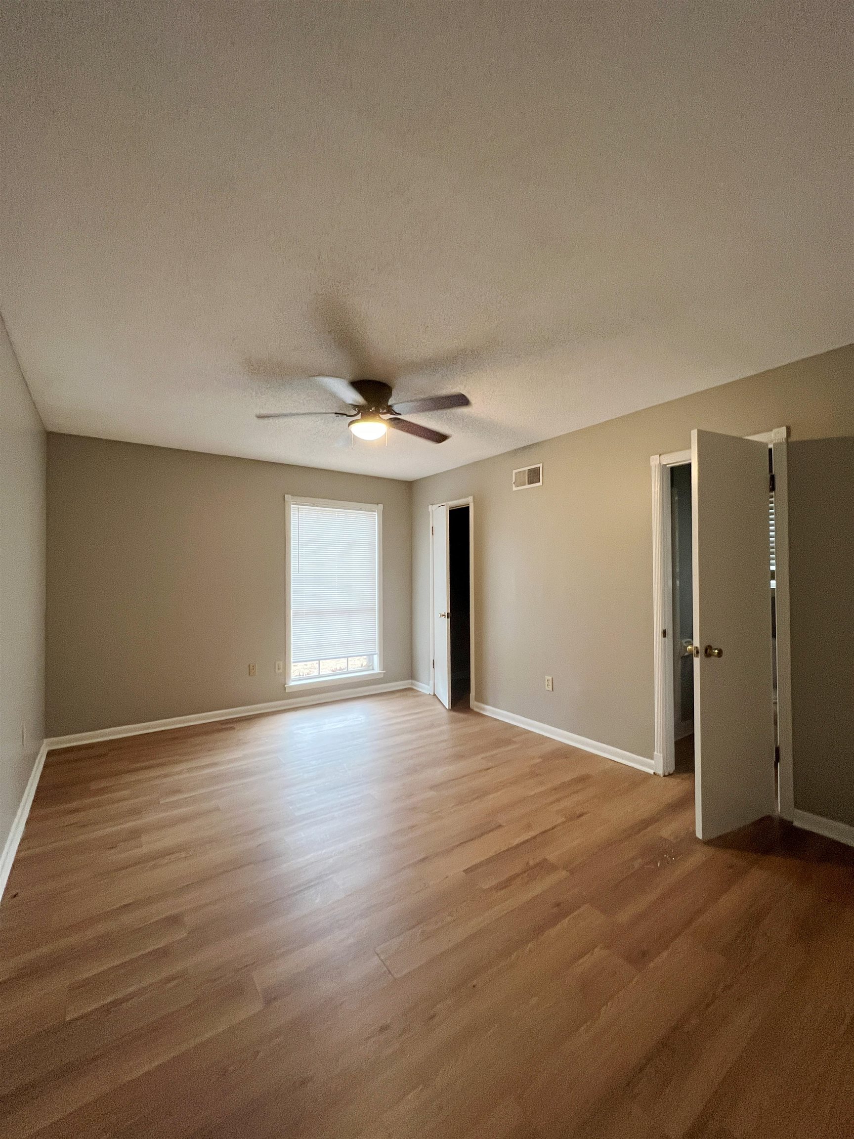 3169 Flint Drive Memphis, TN 38115 - Photo 6 of 13 a view of an empty room with wooden floor and a window