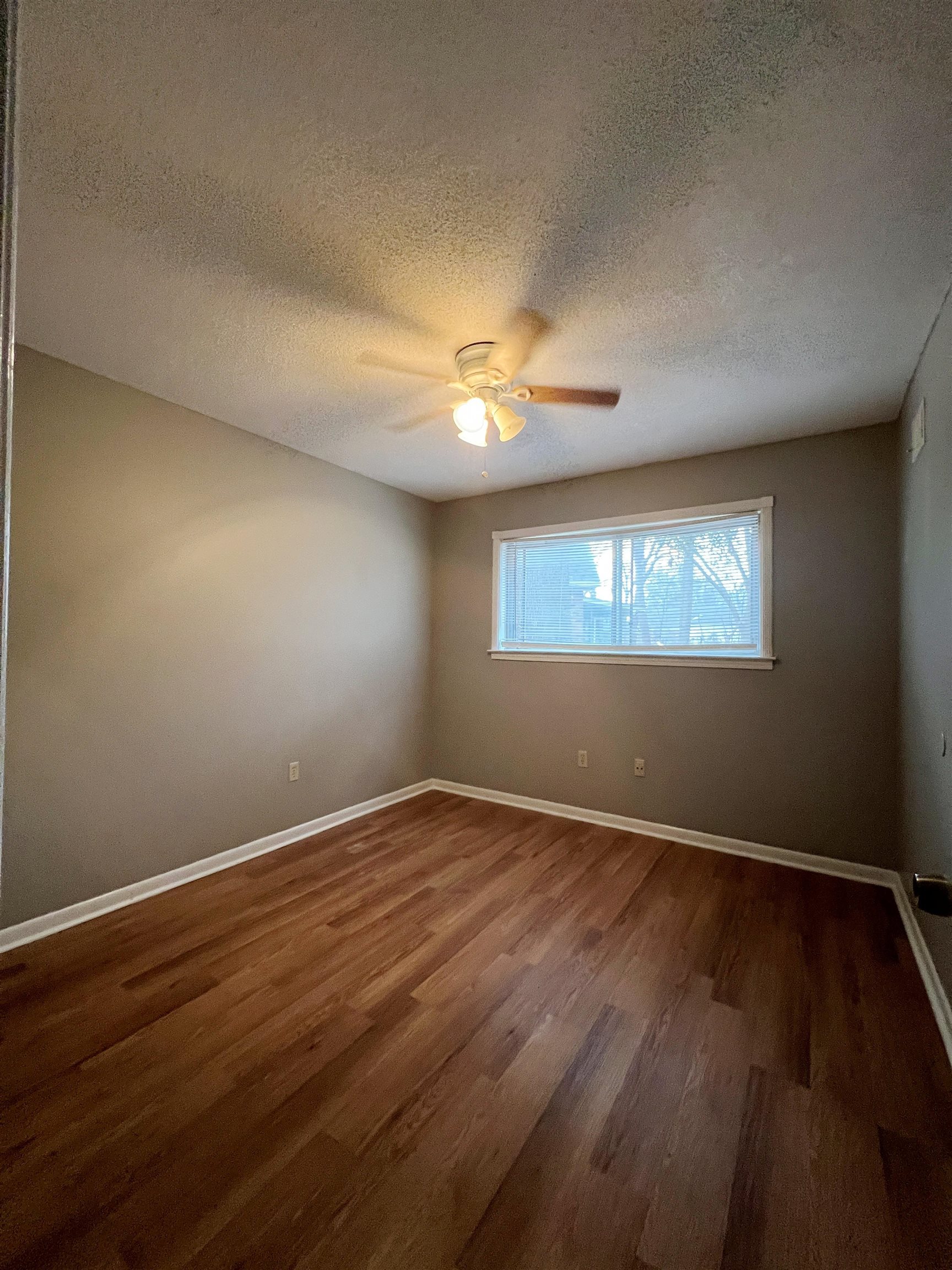 3169 Flint Drive Memphis, TN 38115 - Photo 9 of 13 a view of an empty room with wooden floor and a window