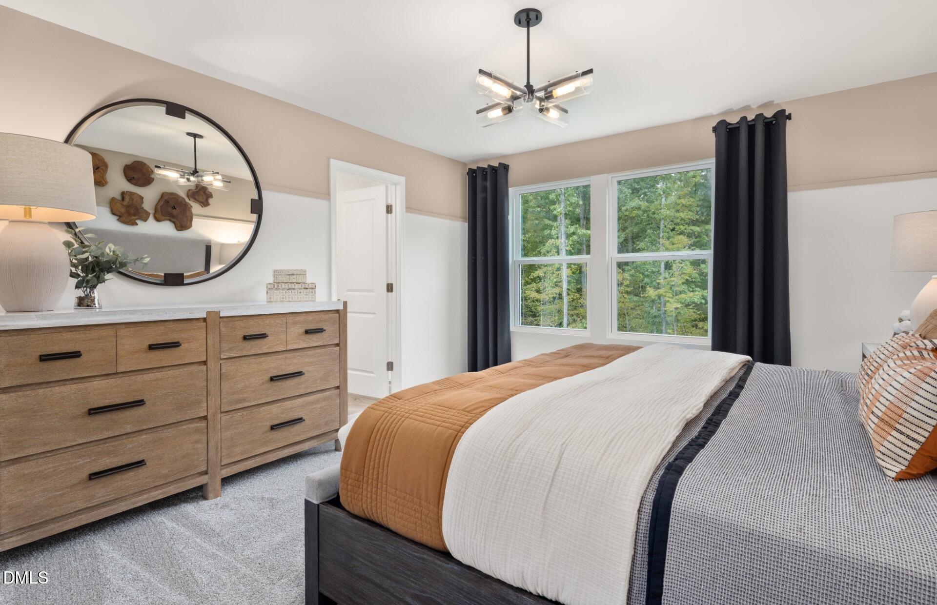 605 Timber Terrace Drive Durham, NC 27704 - Photo 16 of 31 a bedroom with a large bed and a dresser