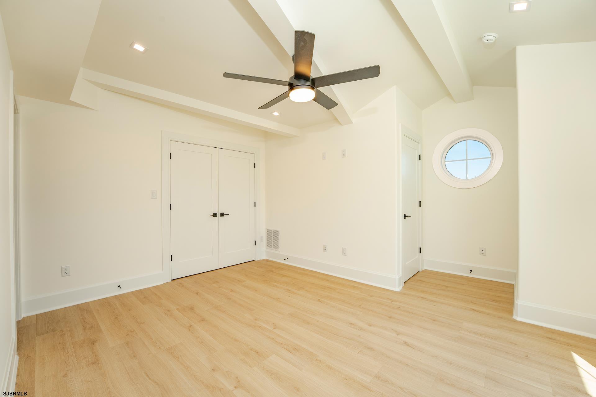 27 Spruce Road Ocean City, NJ 08226 - Photo 65 of 92 a view of a room with wooden floor and a ceiling fan