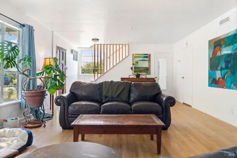 a living room with furniture and a potted plant