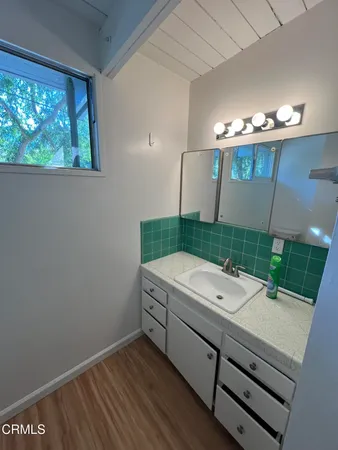 a bathroom with a sink a mirror and a toilet