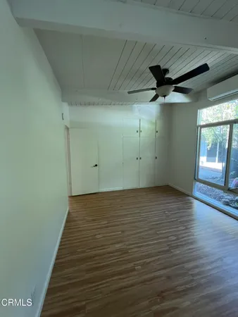 a view of a room with wooden floor