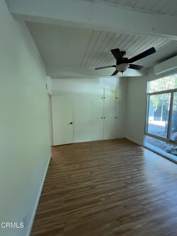 a view of a room with wooden floor