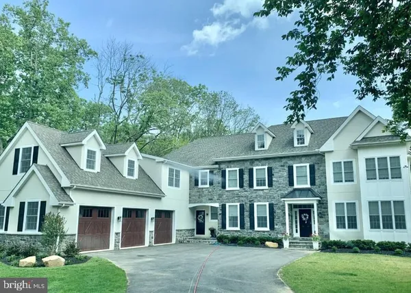 front view of a brick house with a yard