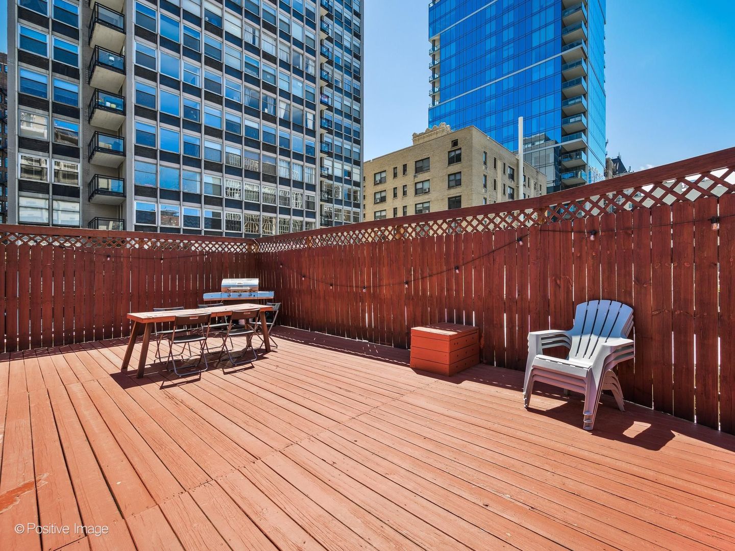 33 East Division Street Chicago, IL 60611 - Photo 22 of 34 a view of a roof deck with wooden floor and furniture