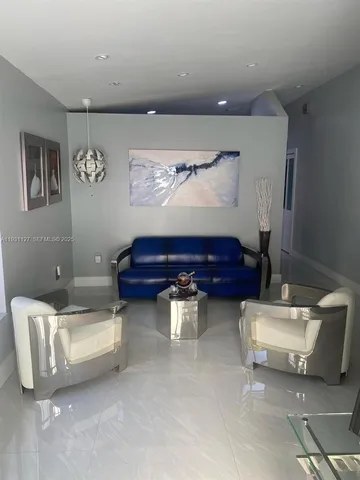 a living room with furniture and wall paintings