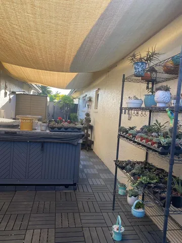 a kitchen with granite countertop wooden cabinets stainless steel appliances and sink
