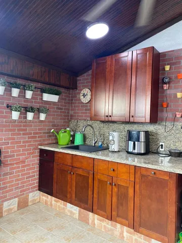 a roof deck with table and chairs with wooden floor