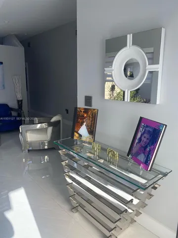 a living room with furniture and a mirror