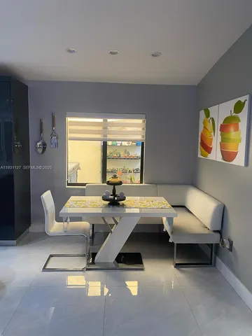 a living room with furniture and floor to ceiling window