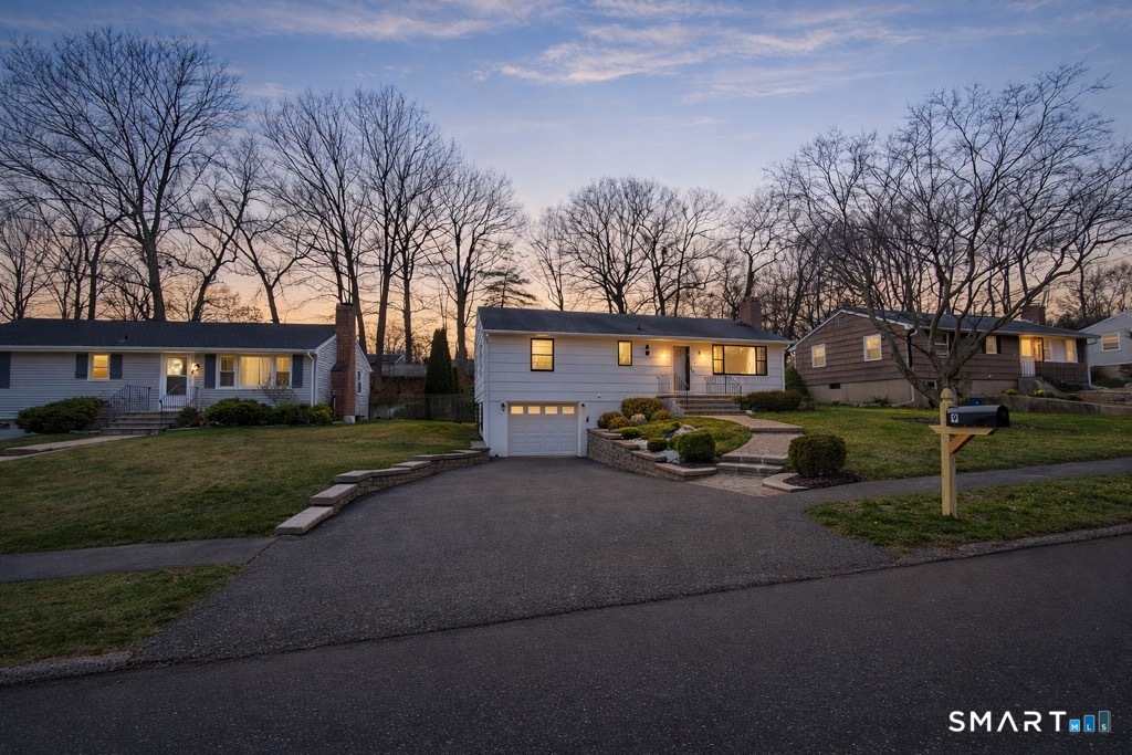 a view of a house with a yard and garage