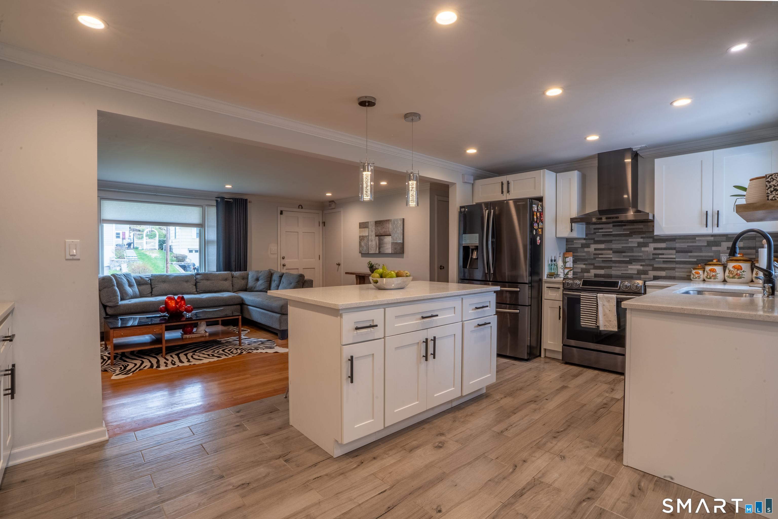 9 Cobblers Lane Norwalk, CT 06851 - Photo 12 of 29 a kitchen with stainless steel appliances granite countertop a refrigerator a stove top oven a sink dishwasher and white cabinets with wooden floor