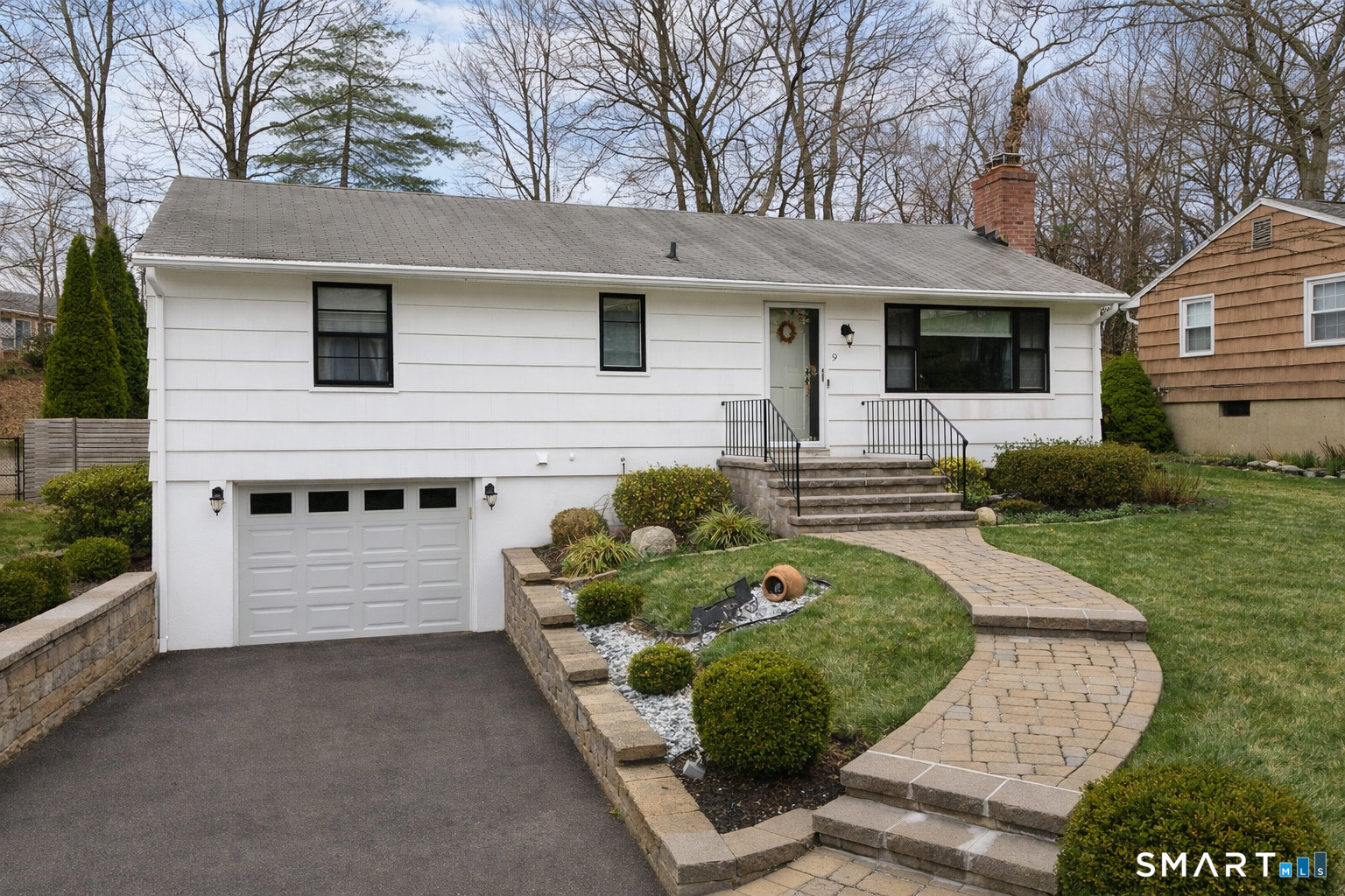 9 Cobblers Lane Norwalk, CT 06851 - Photo 29 of 29 a front view of a house with a yard and garage