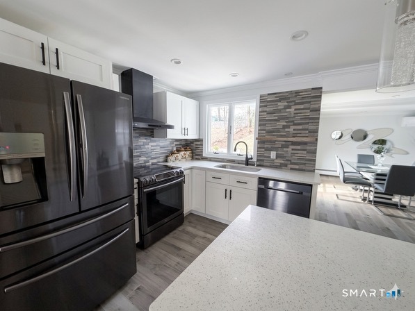 9 Cobblers Lane Norwalk, CT 06851 - Photo 4 of 29 a kitchen with stainless steel appliances granite countertop a refrigerator sink and stove
