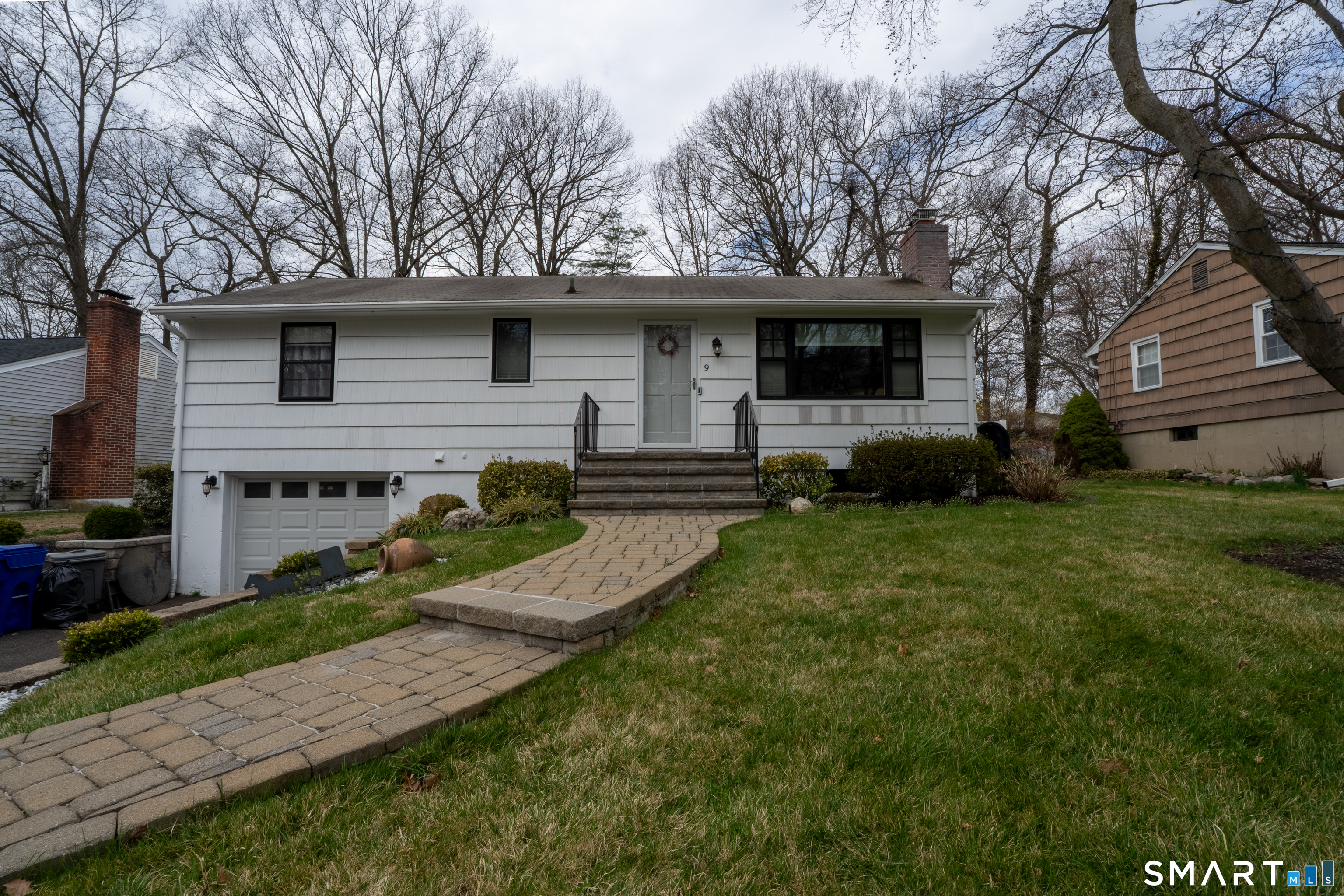 9 Cobblers Lane Norwalk, CT 06851 - Photo 6 of 29 a front view of a house with a yard and trees