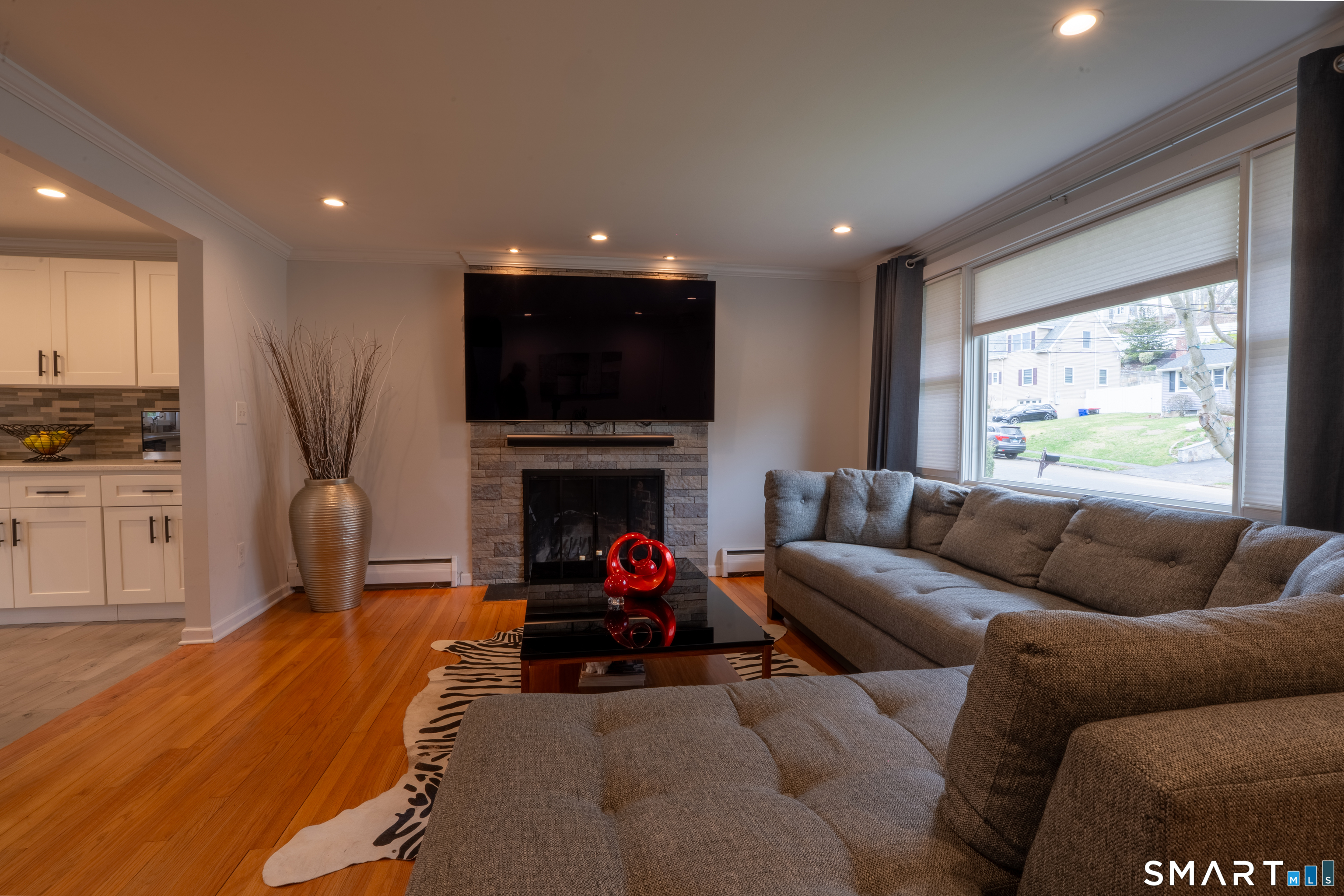 9 Cobblers Lane Norwalk, CT 06851 - Photo 8 of 29 a living room with furniture a fireplace and a flat screen tv