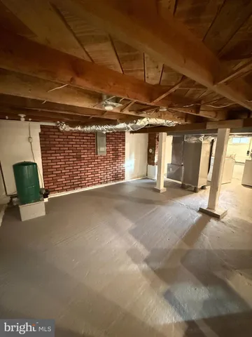 a view of empty room with wooden walls