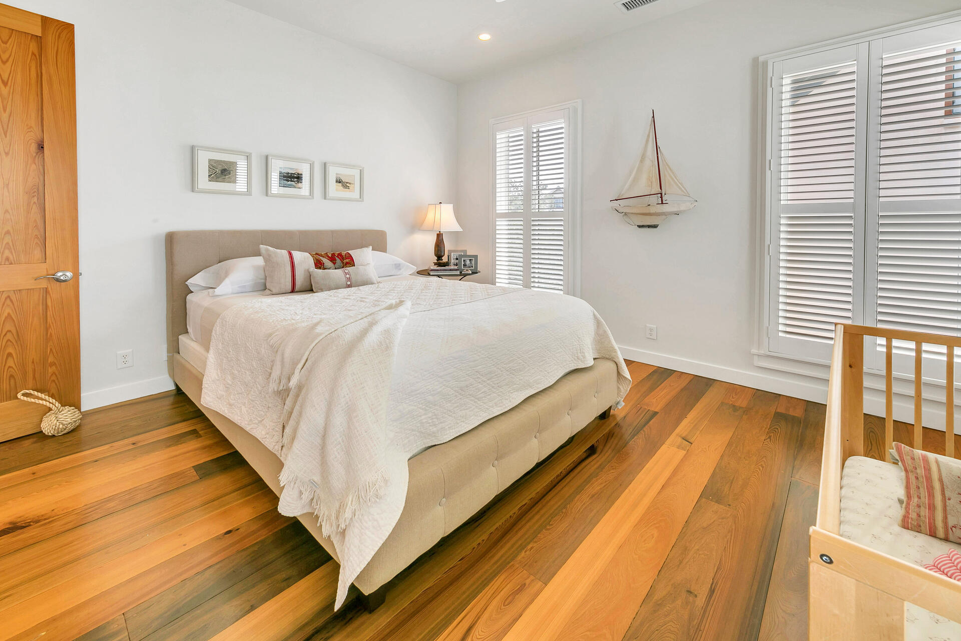 204 East Water Street Inlet Beach, FL 32461 - Photo 25 of 57 a spacious bedroom with a bed and wooden floor