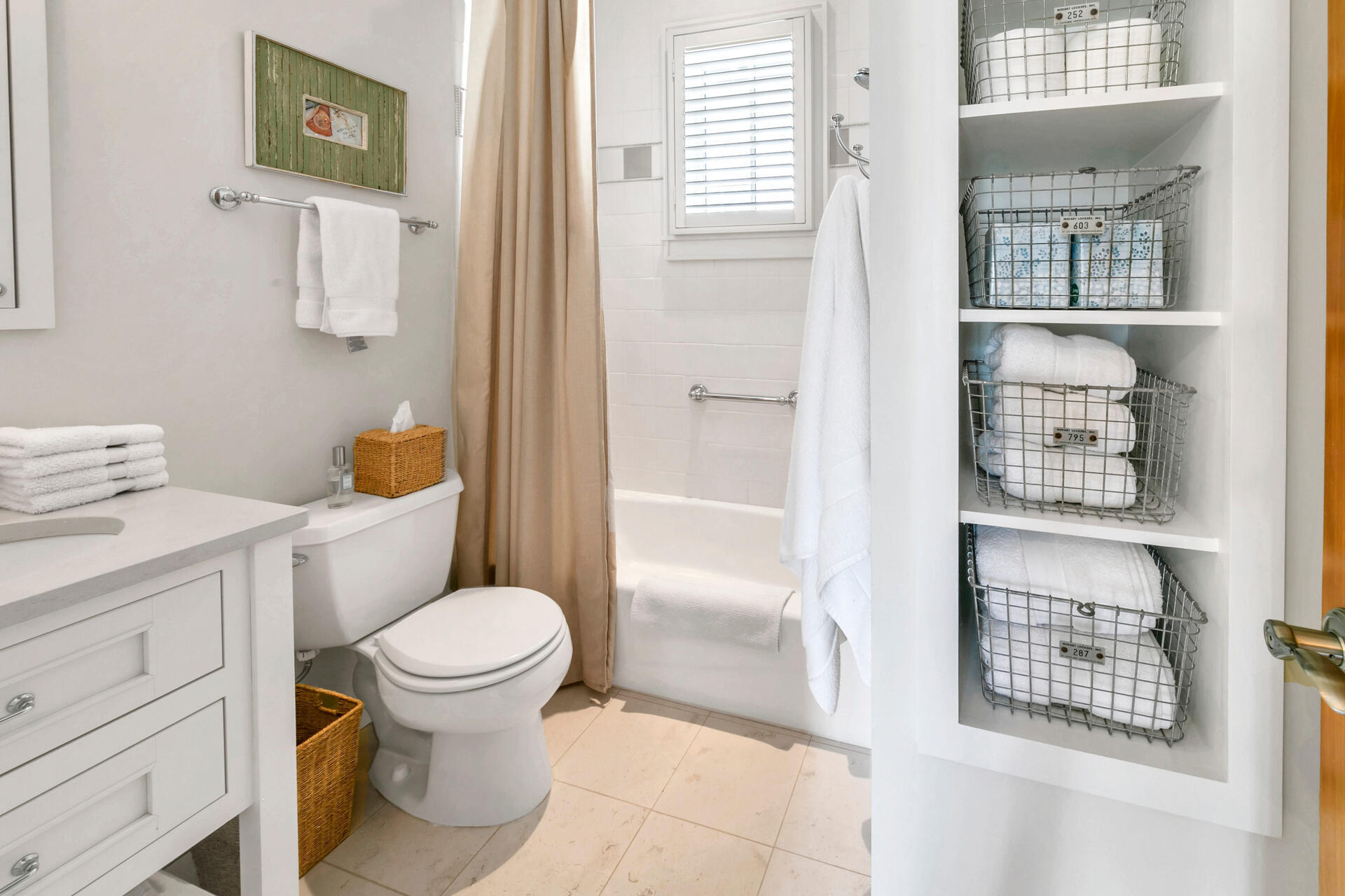 204 East Water Street Inlet Beach, FL 32461 - Photo 27 of 57 a white toilet sitting next to a bathroom sink and tub