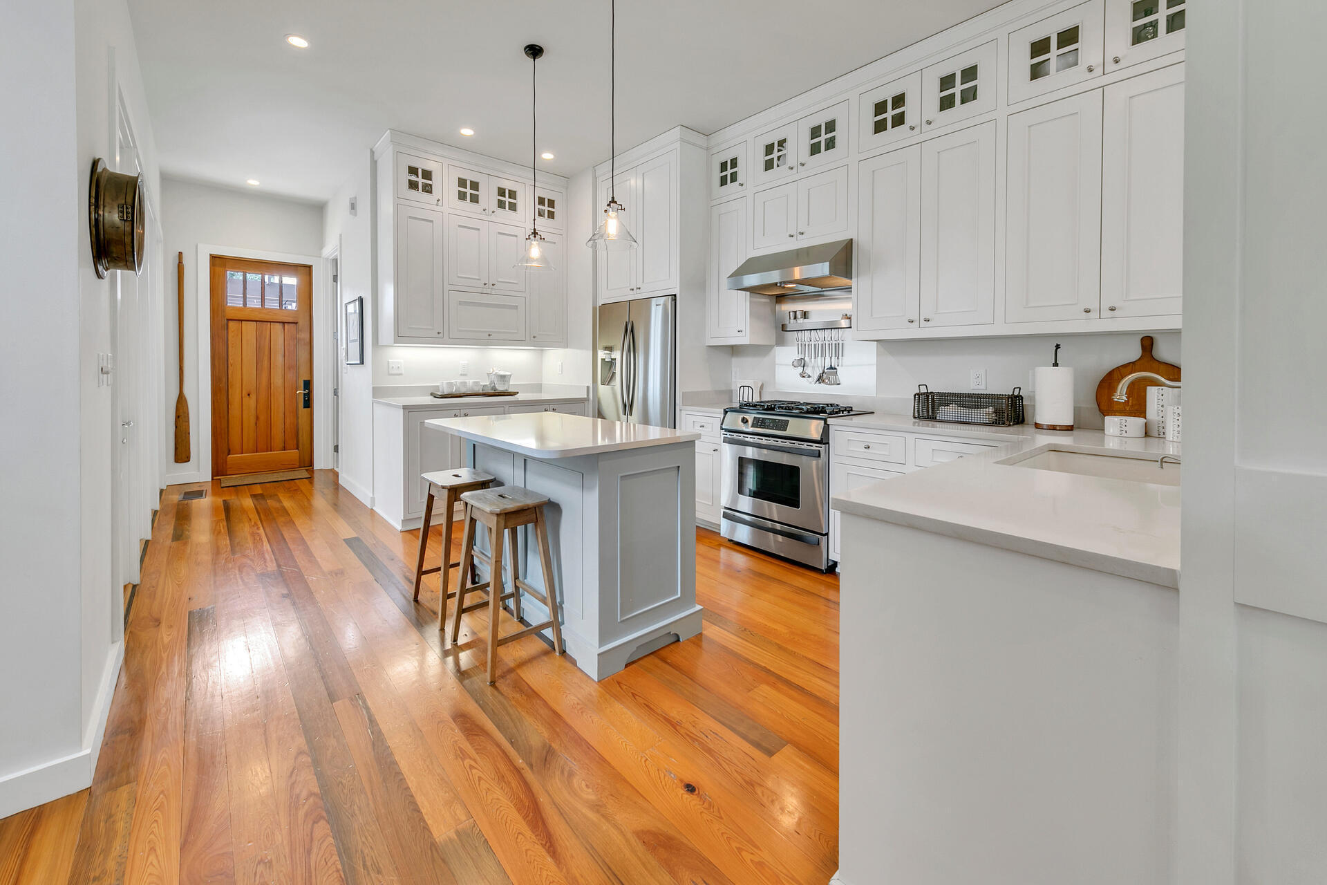 204 East Water Street Inlet Beach, FL 32461 - Photo 5 of 57 a kitchen with stainless steel appliances granite countertop a stove top oven a sink dishwasher and a refrigerator with wooden floor