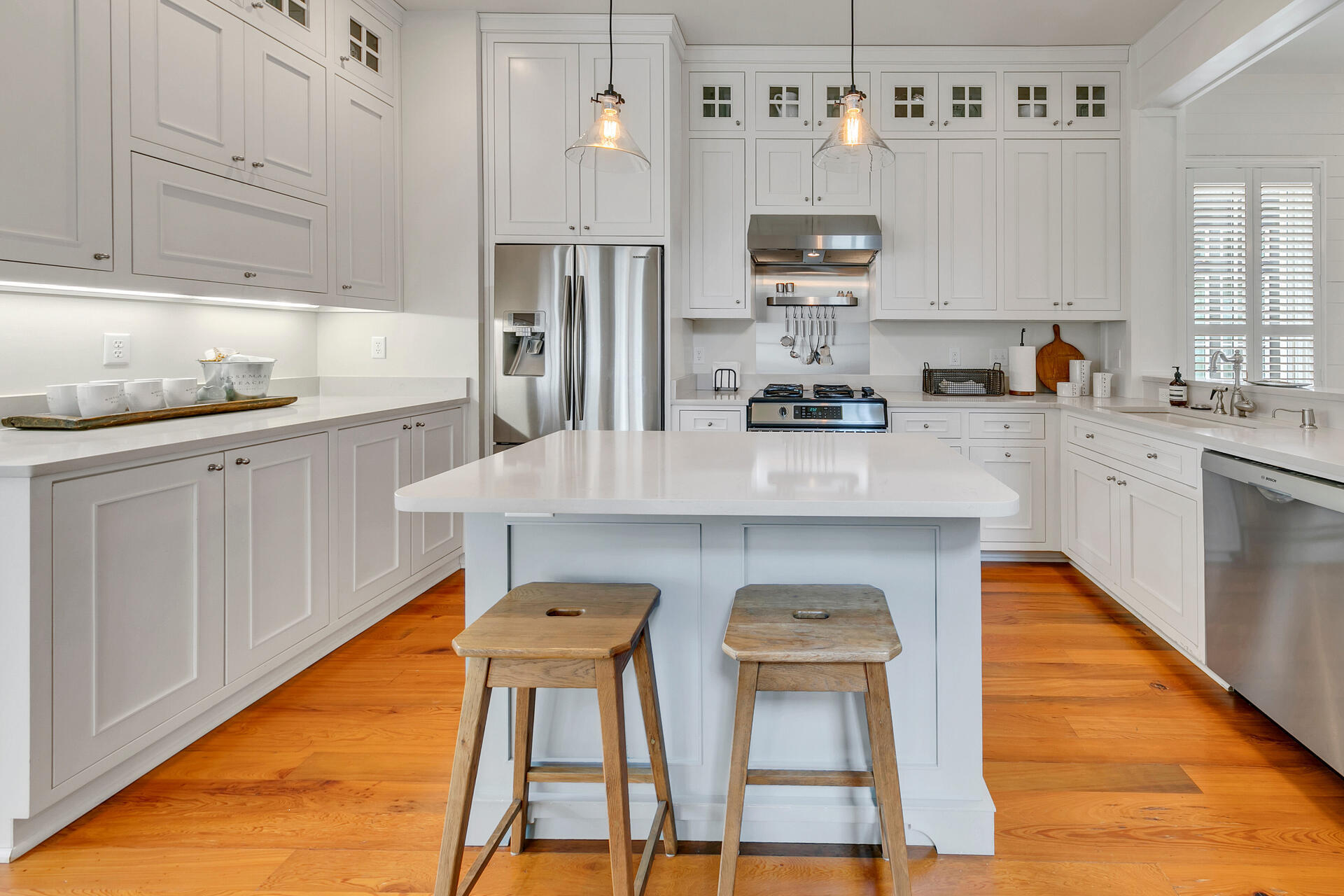 204 East Water Street Inlet Beach, FL 32461 - Photo 6 of 57 a kitchen with stainless steel appliances granite countertop a refrigerator a sink dishwasher and white cabinets with wooden floor