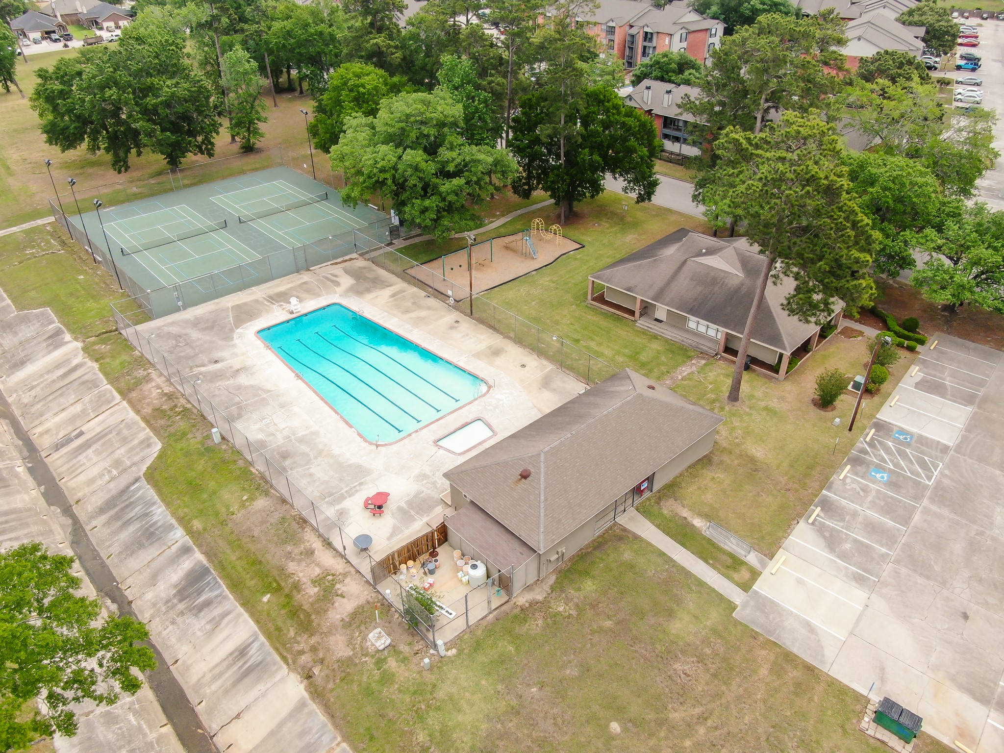 114 Regency Way Conroe, TX 77304 - Photo 46 of 48 Rivershire Community Pool, Tennis Courts, playground and clubhouse.
