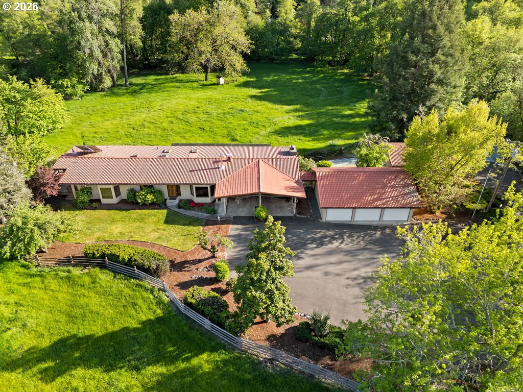 2233 East Riverside Drive Myrtle Creek, OR 97457 - Photo 1 of 47 an aerial view of a house with a garden