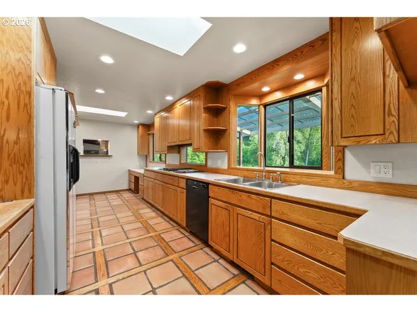 a kitchen with stainless steel appliances granite countertop a sink and cabinets