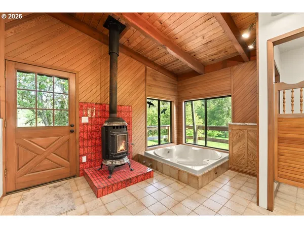 a living room with a fireplace furniture and a large window