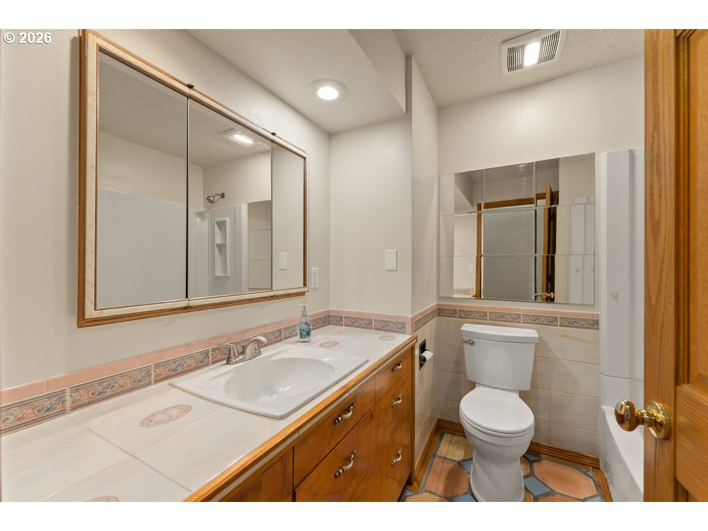 2233 East Riverside Drive Myrtle Creek, OR 97457 - Photo 29 of 47 a bathroom with a granite countertop sink mirror vanity and toilet
