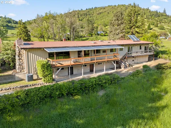 a front view of house with a garden and swimming pool