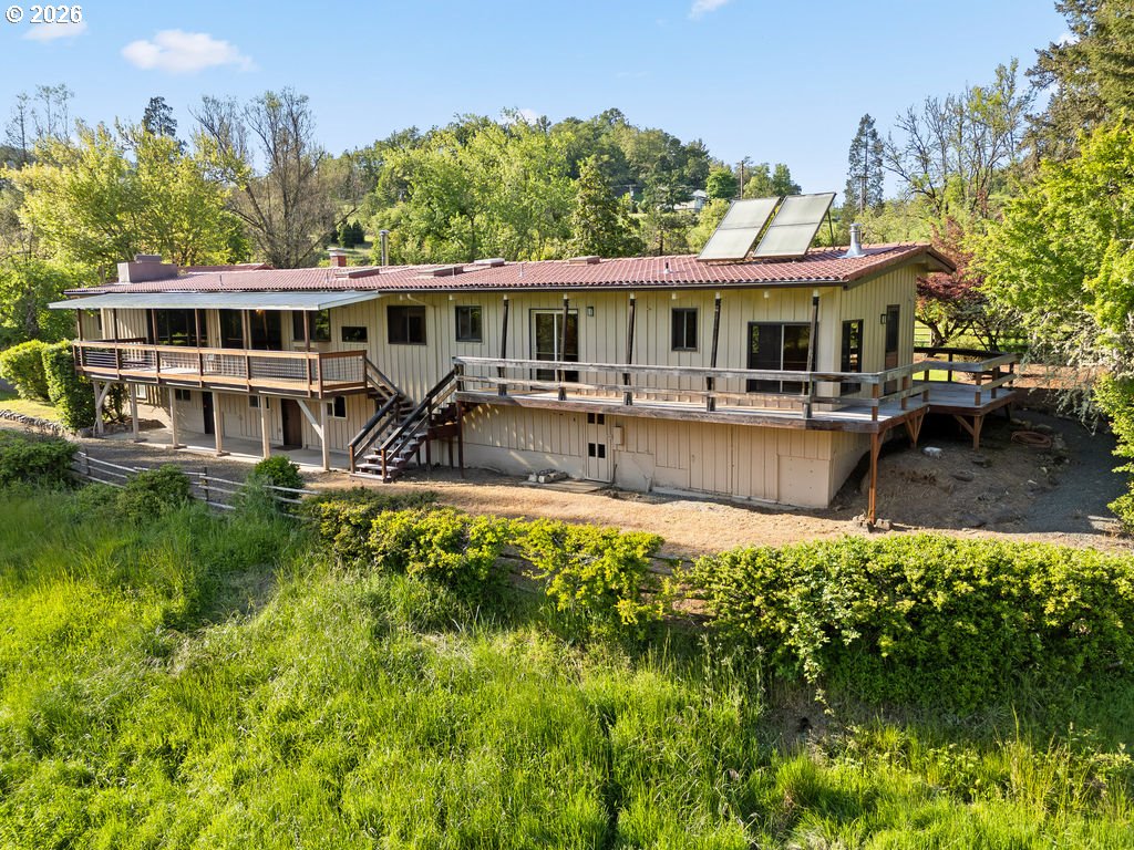 2233 East Riverside Drive Myrtle Creek, OR 97457 - Photo 35 of 47 a front view of house with a garden and swimming pool
