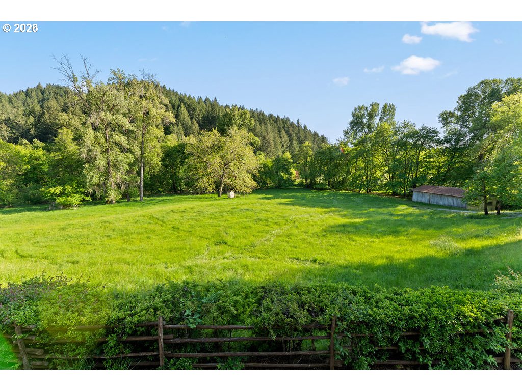 2233 East Riverside Drive Myrtle Creek, OR 97457 - Photo 39 of 47 a view of a field with a tree in the background