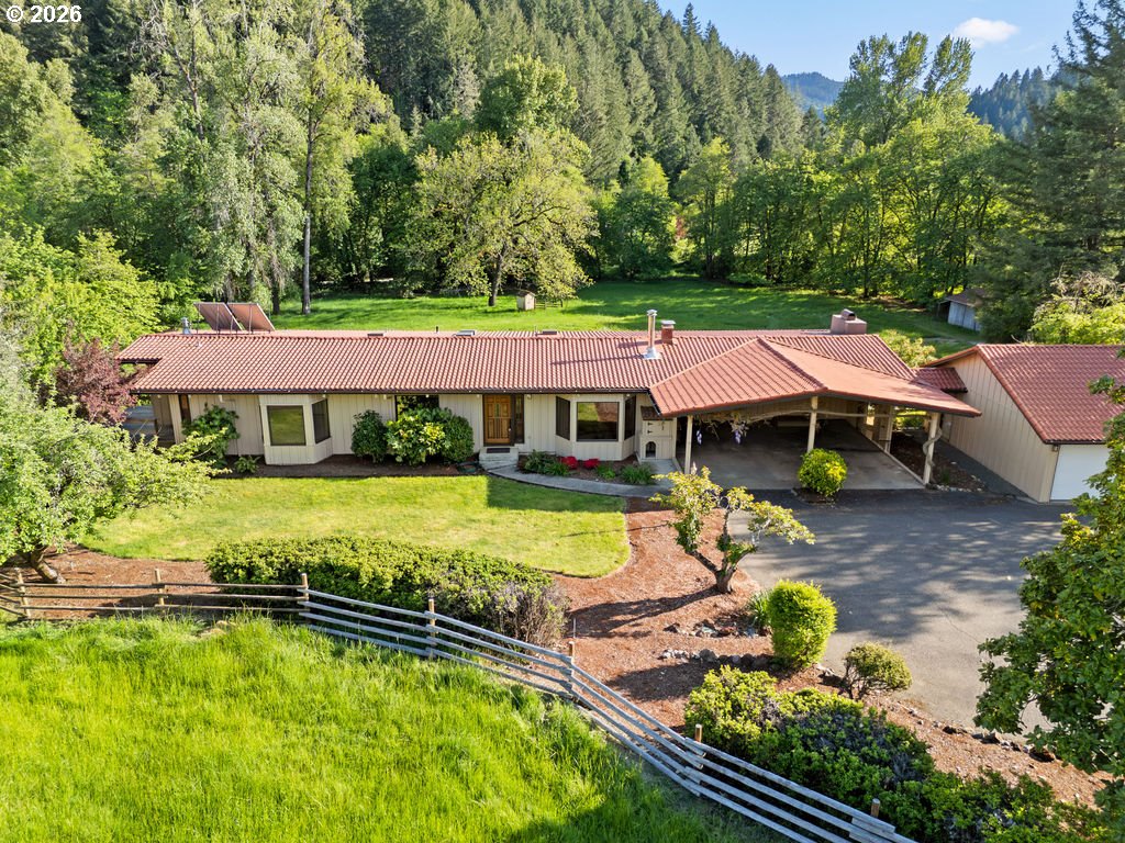 2233 East Riverside Drive Myrtle Creek, OR 97457 - Photo 4 of 47 an aerial view of a house with swimming pool and large trees